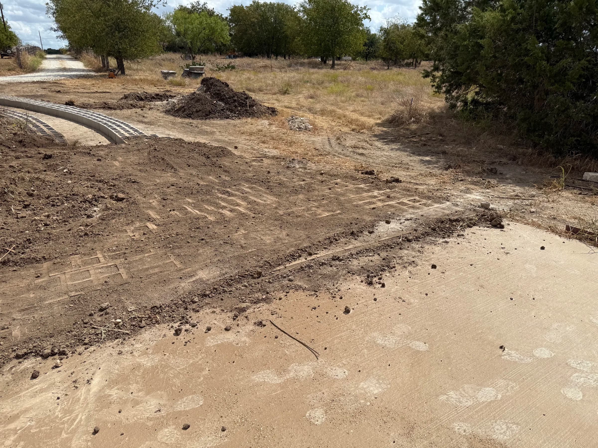 Prepared ground and curved concrete block layout at the White Hall property