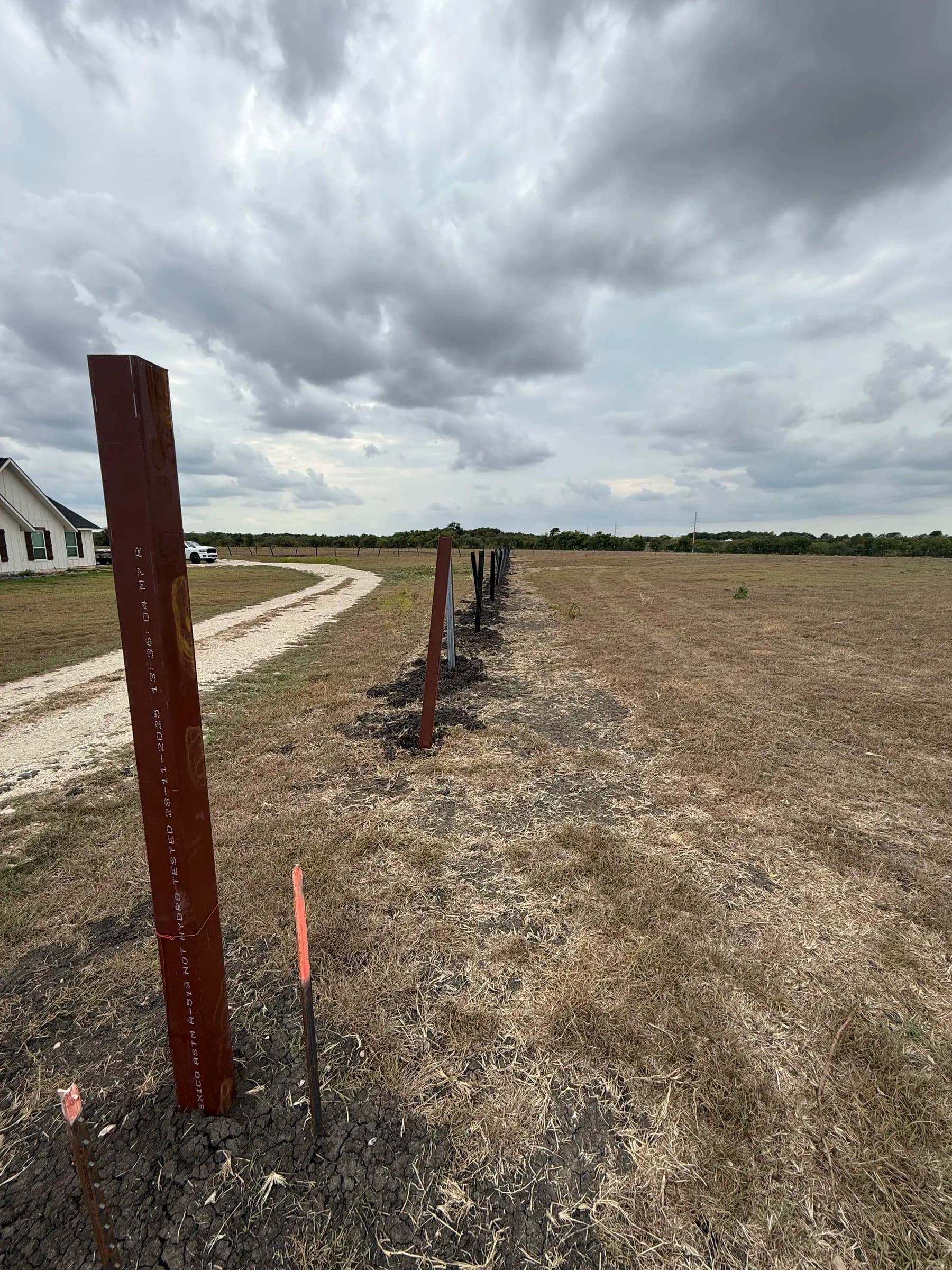 Steel fence posts extending across the property during installation in Holland