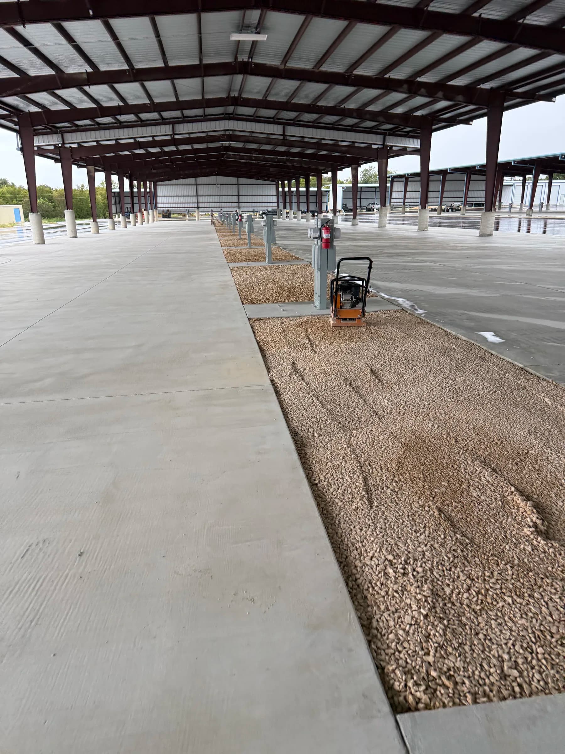 Compacted gravel and a plate compactor around electrical pedestals at the Killeen RV storage property